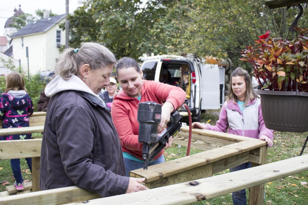 Disability Advocates at work building a ramp to help one their consumers get in and out the house.